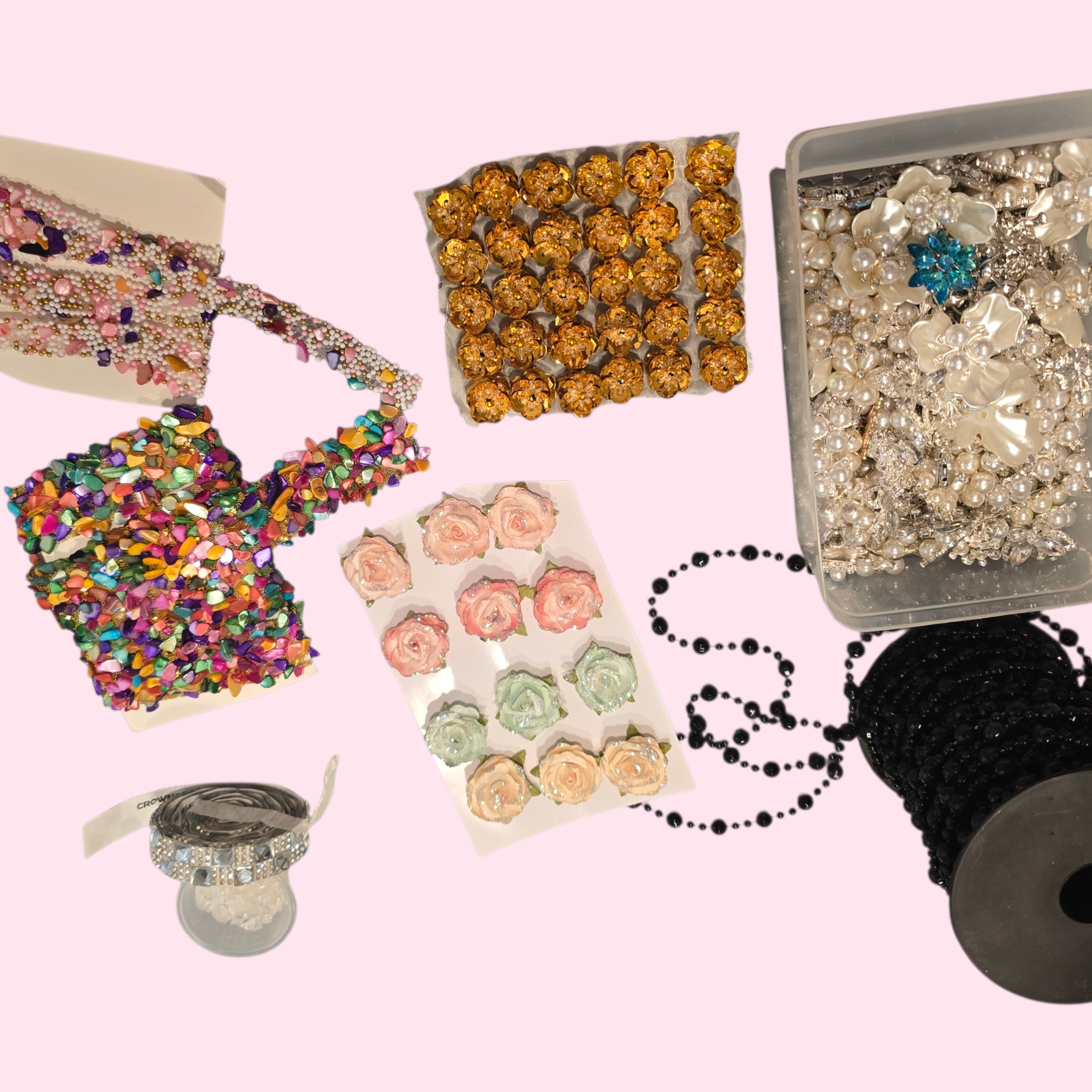 Assorted embellishments including beads, rhinestones, floral accents, and trims used as creative inspiration in the artist’s studio.