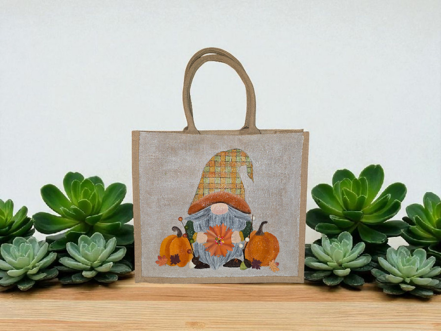 Hand-painted Fall Gnome tote bag with sunflowers, acorns, and berries on metallic jute background