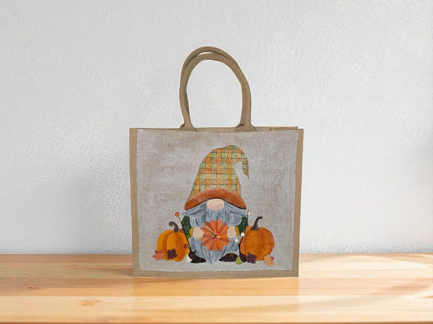 Hand-painted Fall Gnome tote bag with sunflowers, acorns, and berries on metallic jute background