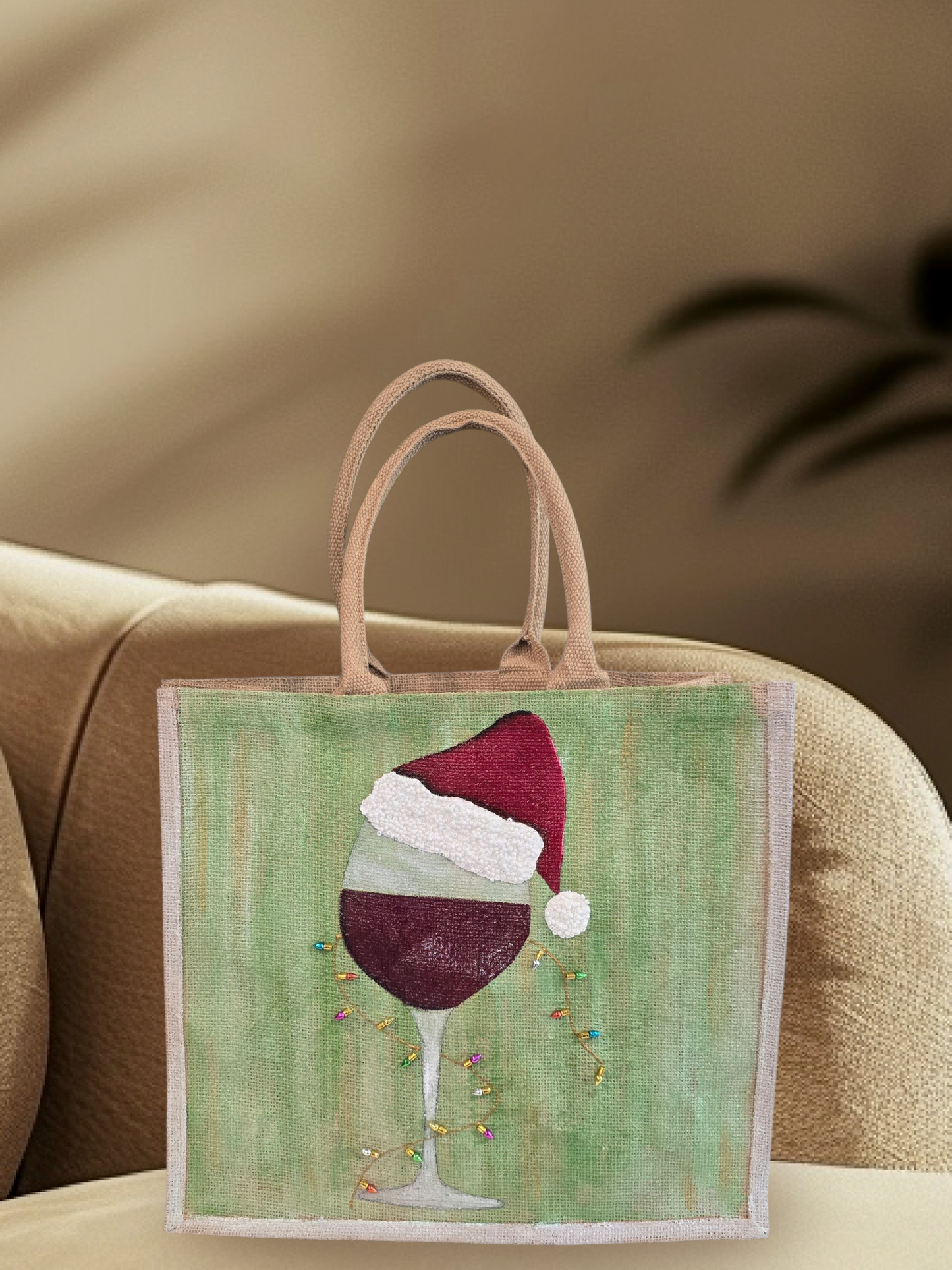 Hand-painted jute tote with a wine glass wearing a Santa hat and tiny holiday lights.