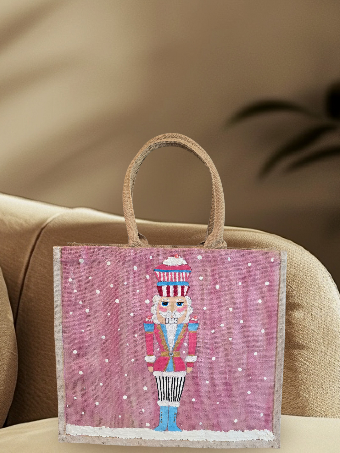 Hand-painted pink Nutcracker on a snowy background, on a jute tote bag.