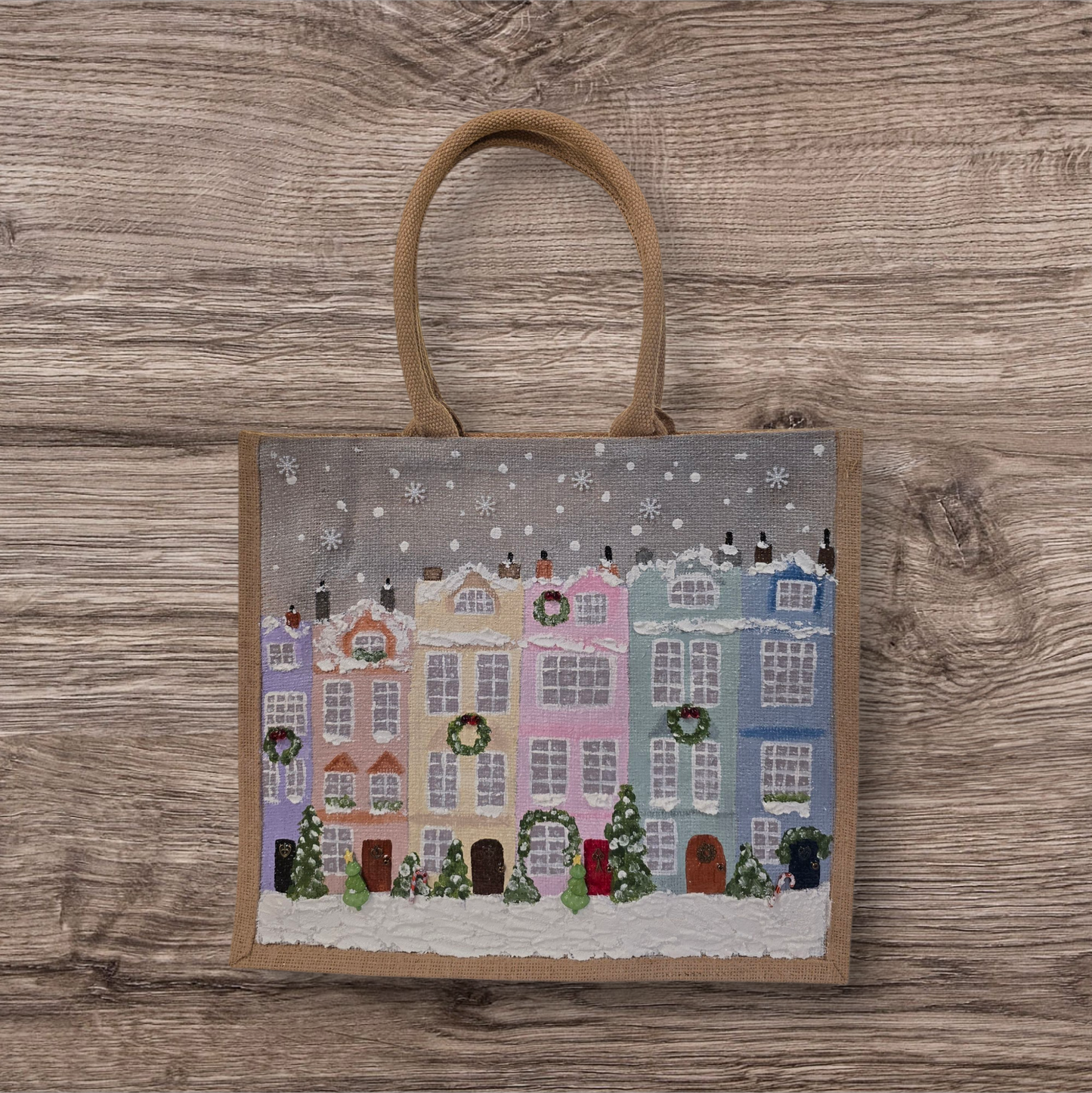 Hand-painted pastel gingerbread row houses in the snow on jute tote, Holiday village street artwork on artisan lined tote, Pastel Christmas houses tote with wreaths and snowfall