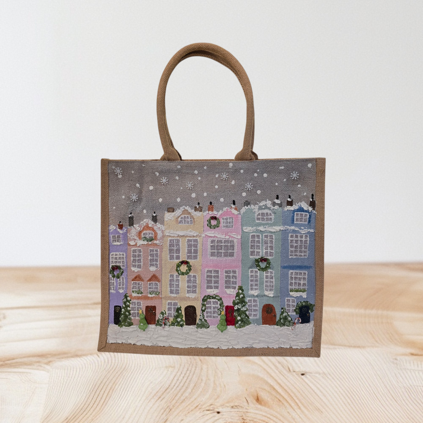 Hand-painted pastel gingerbread row houses in the snow on jute tote, Holiday village street artwork on artisan lined tote, Pastel Christmas houses tote with wreaths and snowfall