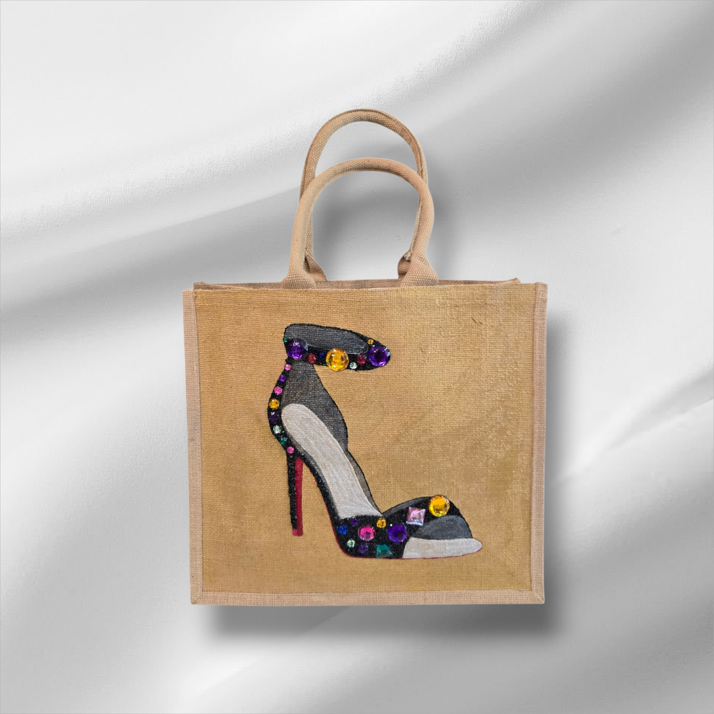 Hand-painted black stiletto tote bag with gold jeweled accents on natural jute background