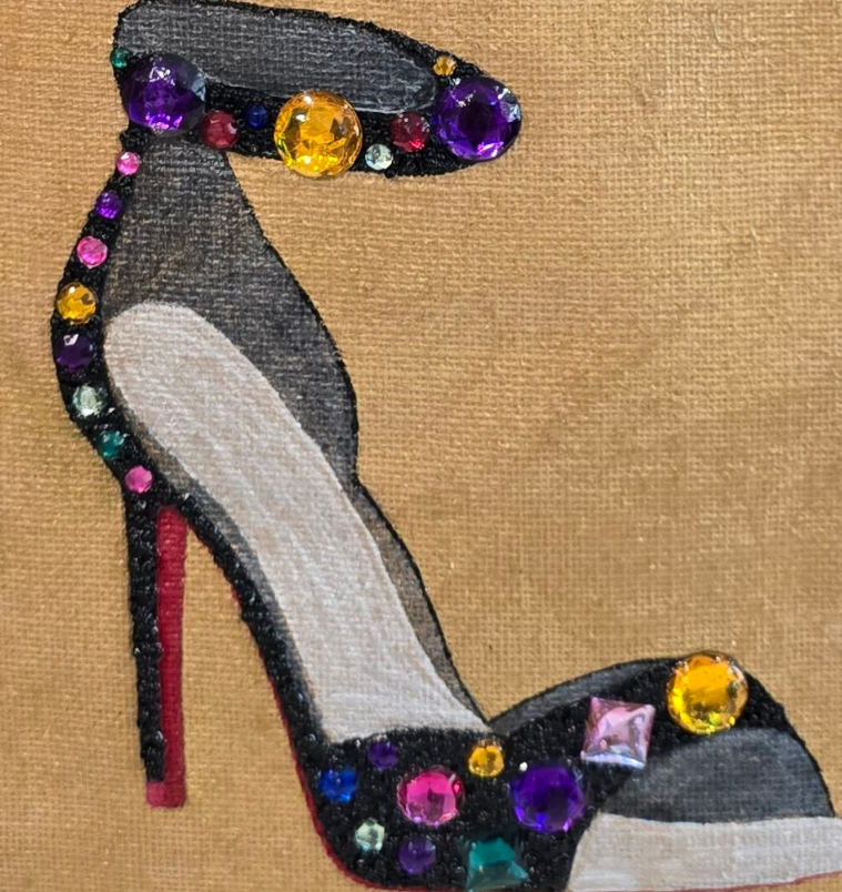 close up of Hand-painted jute shopper tote featuring a jeweled black stiletto shoe embellished with colorful gems and rhinestones, designed as bold wearable fashion art.