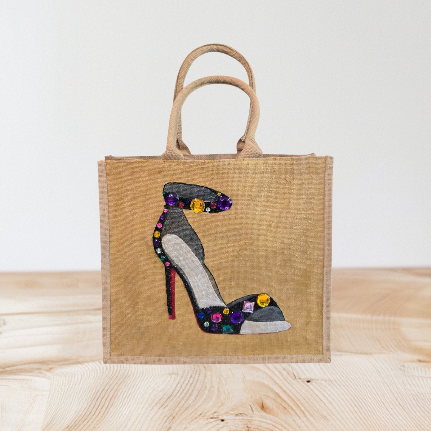 Hand-painted black stiletto tote bag with gold jeweled accents on natural jute background