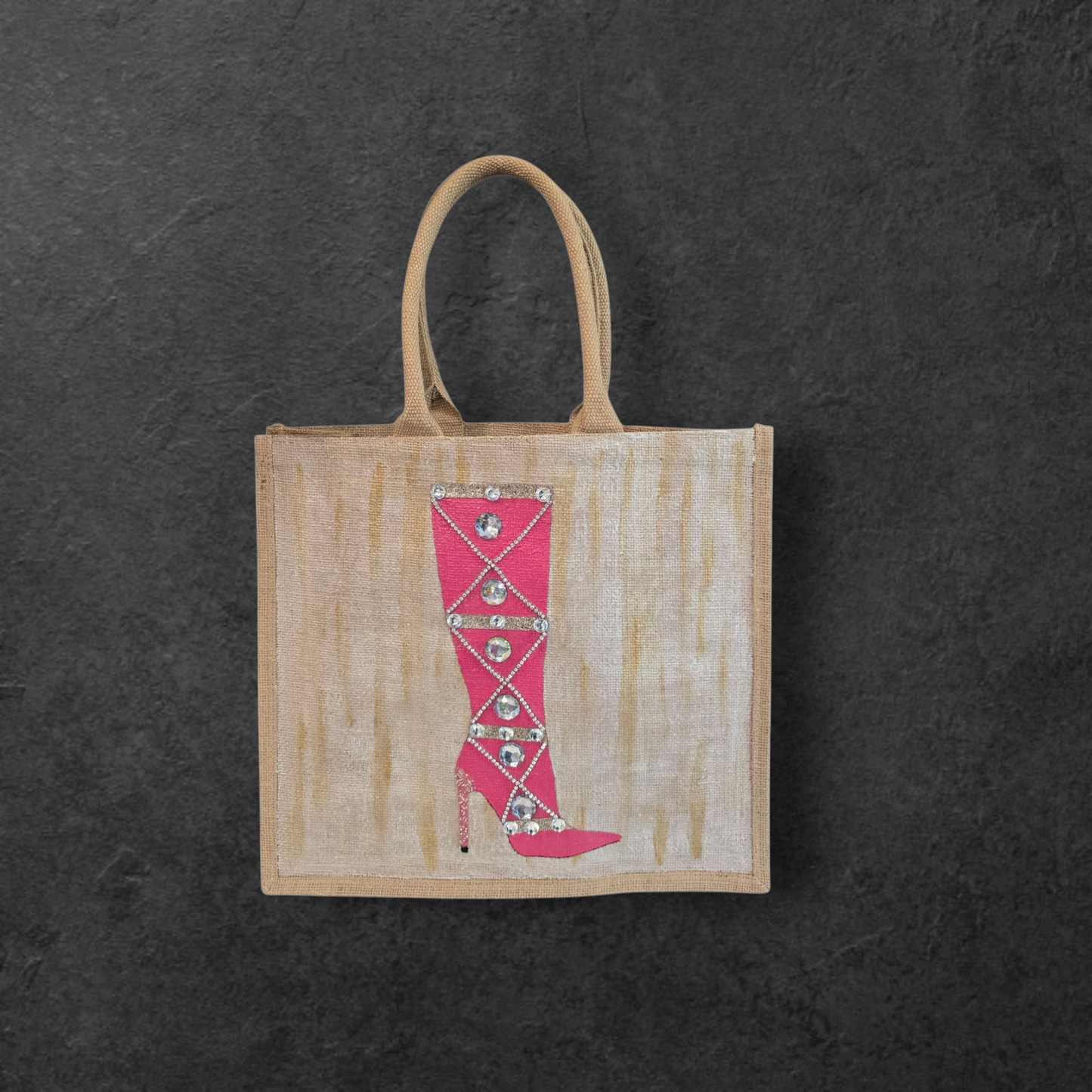 Hand-painted pink rhinestone boot tote bag on natural jute background