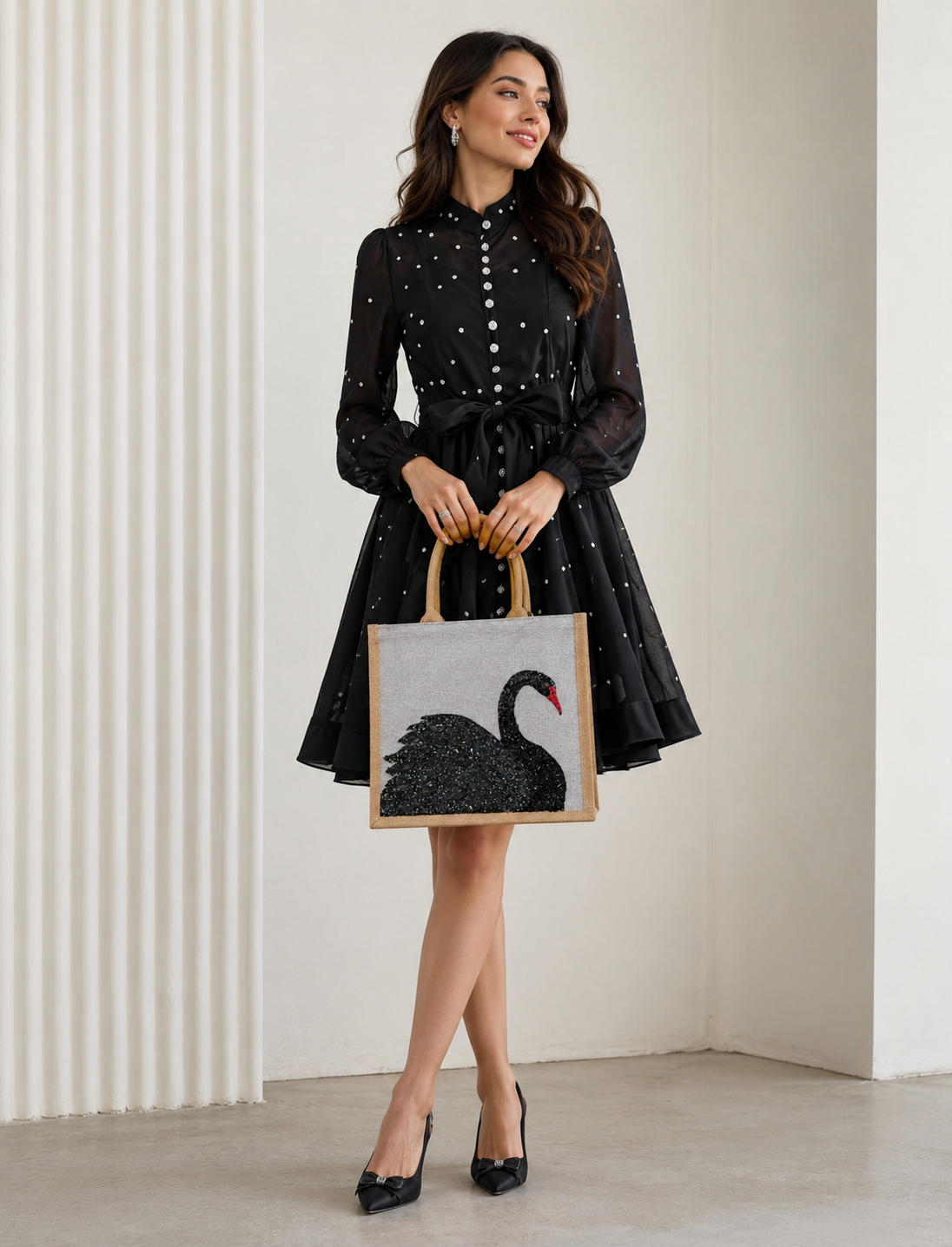 woman holdingHand-painted gray jute tote bag featuring an embellished black swan design with textured shimmer details and a red beak. The structured tote has natural woven handles and a sophisticated neutral color palette inspired by elegant, artisan-style fashion accessories.
