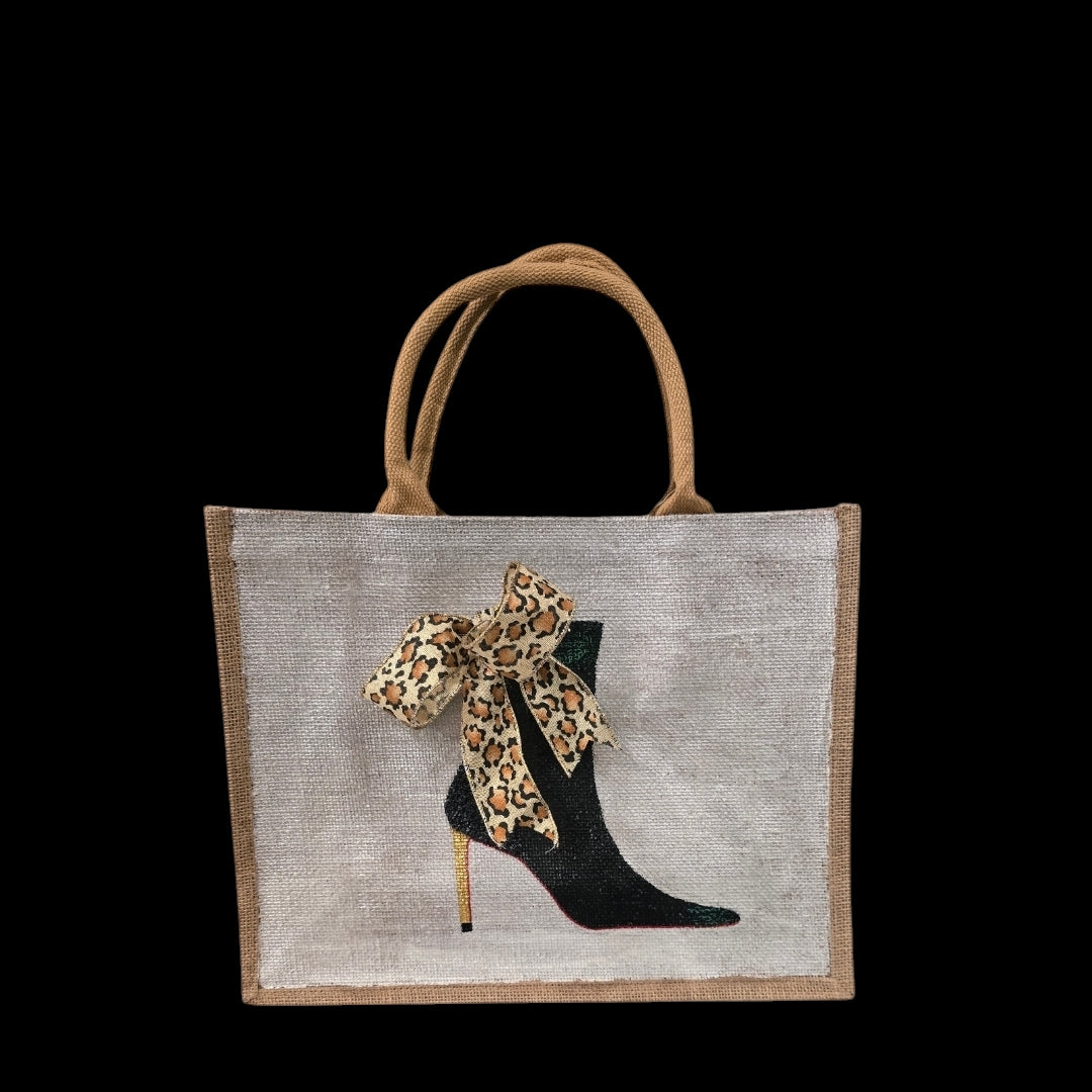 Off white jute tote bag with hand-painted black booties and red soles, featuring beaded embellishments.