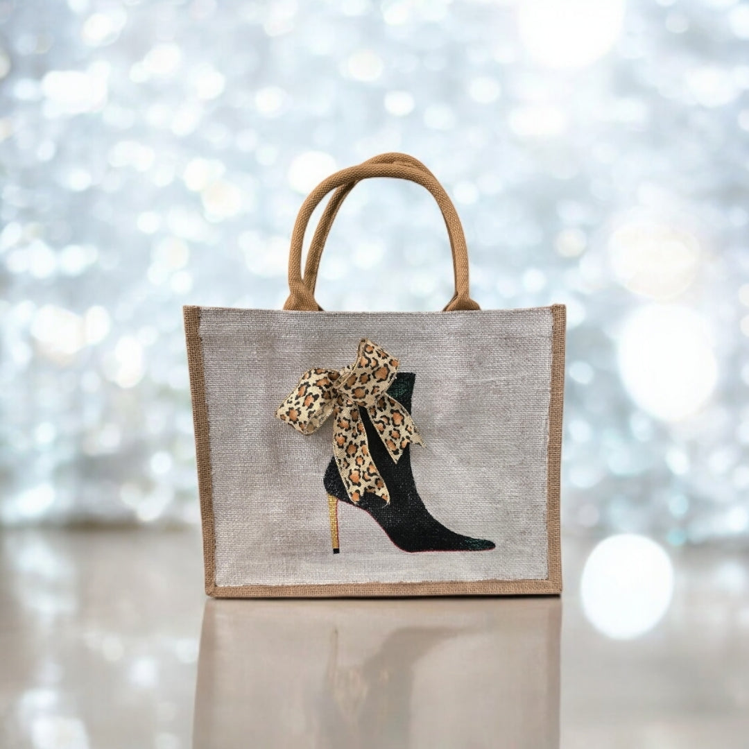 Off white jute tote bag with hand-painted black booties and red soles, featuring beaded embellishments.