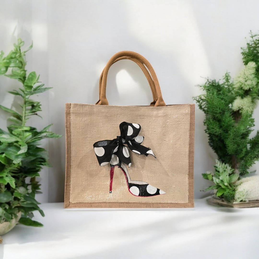 Off white jute tote bag with hand-painted black stilettos, white polka dots, red soles, and beaded accents.