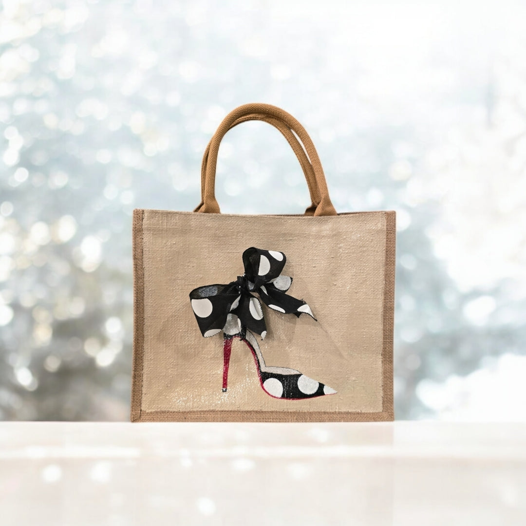 Off white jute tote bag with hand-painted black stilettos, white polka dots, red soles, and beaded accents.