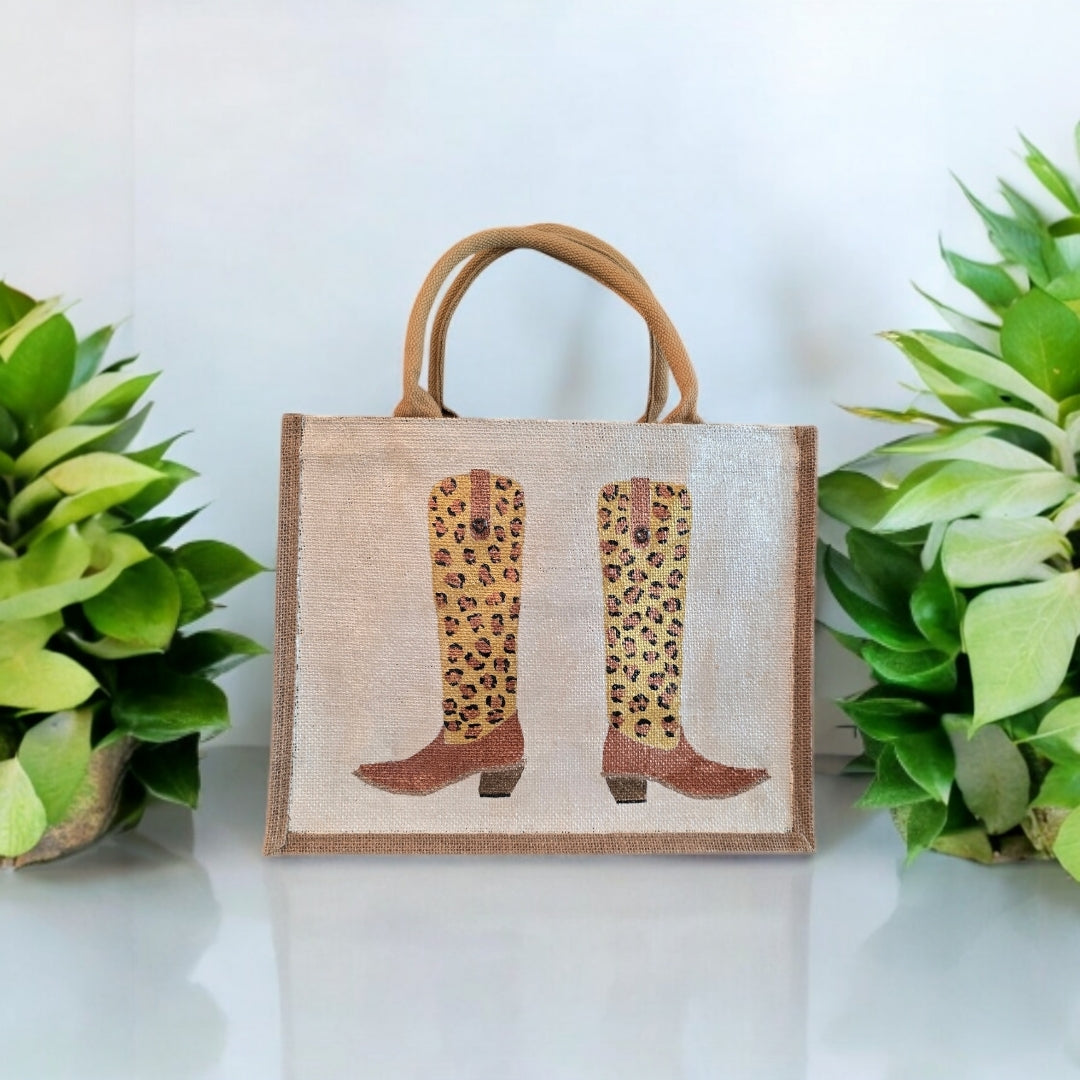 Off white jute tote bag with hand-painted leopard print cowboy boots, detailed with bead accents.