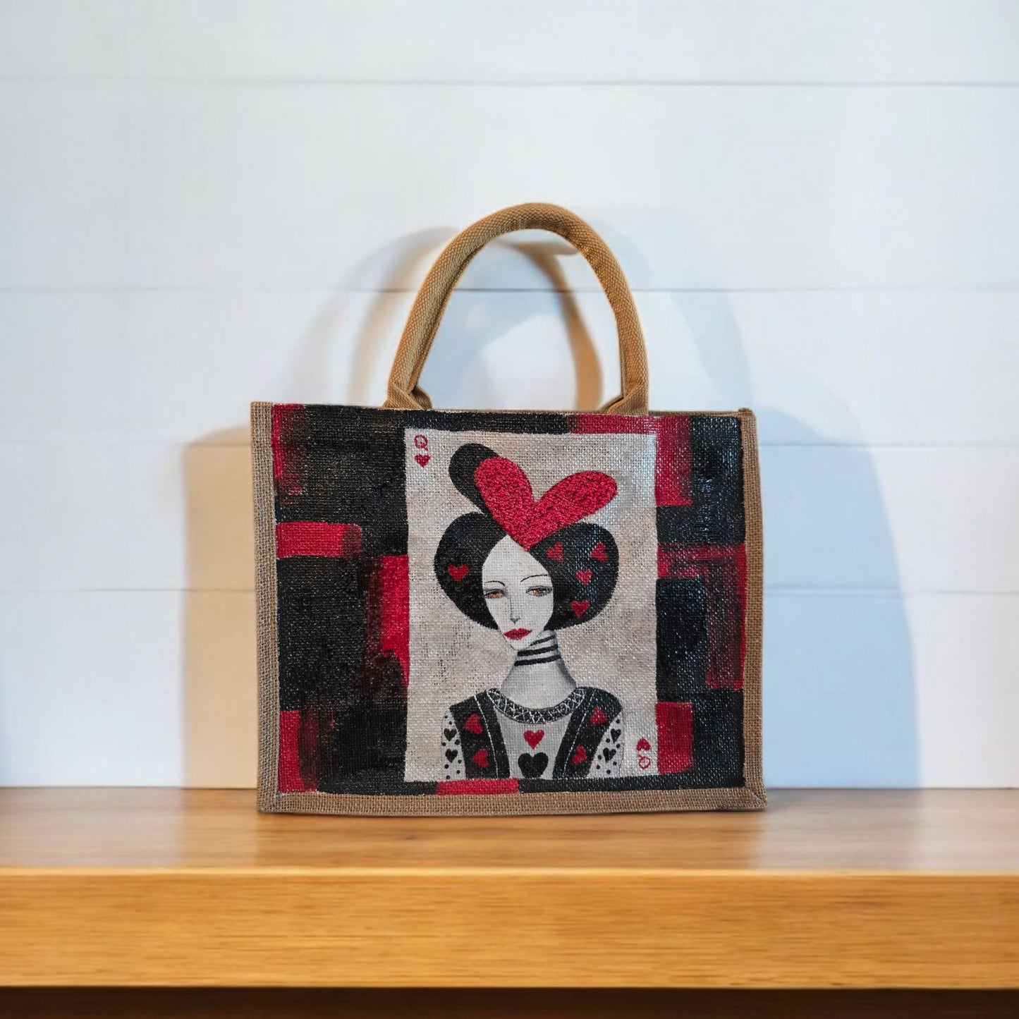 Black jute tote bag with hand-painted Queen of Hearts playing card design and decorative beading.