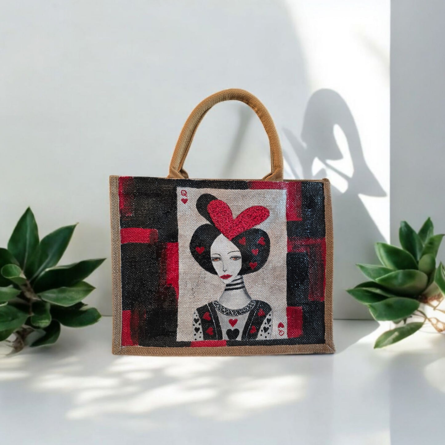 Black jute tote bag with hand-painted Queen of Hearts playing card design and decorative beading.