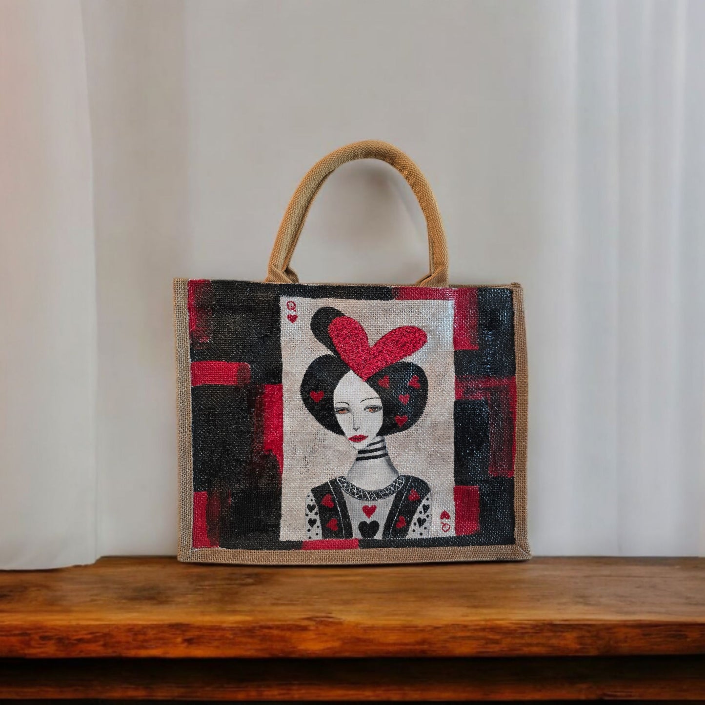 Black jute tote bag with hand-painted Queen of Hearts playing card design and decorative beading.
