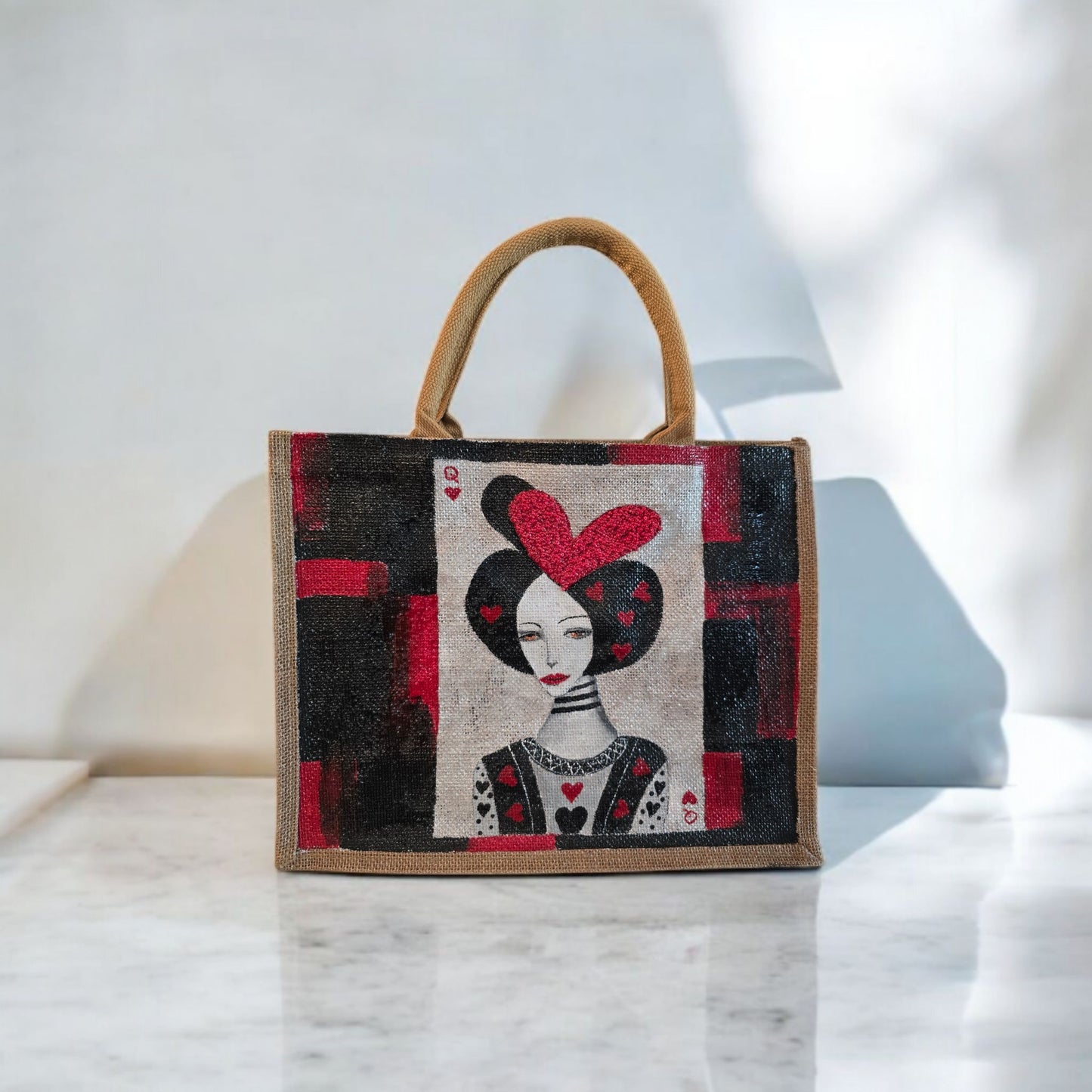 Black jute tote bag with hand-painted Queen of Hearts playing card design and decorative beading.