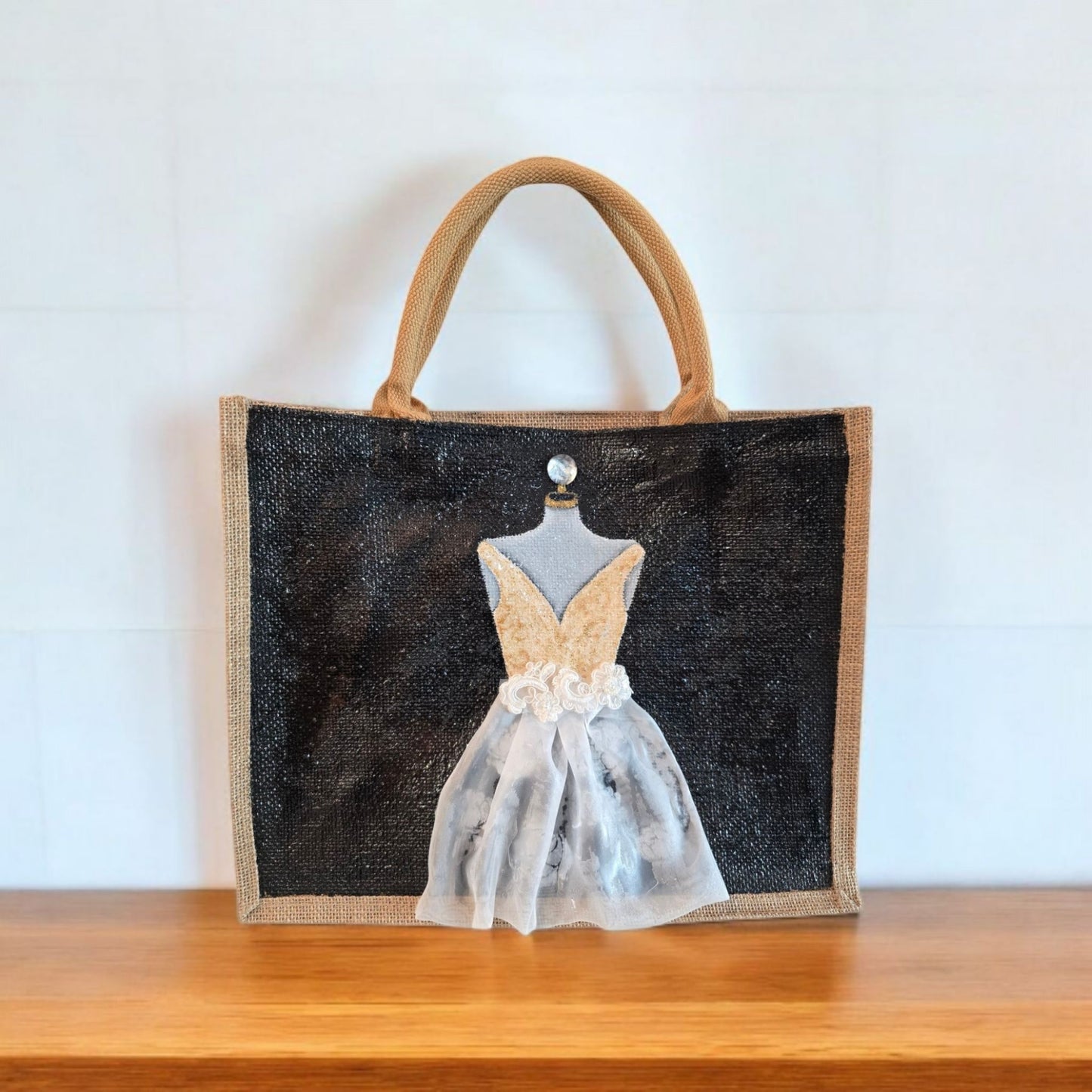 Black jute tote bag with hand-painted white wedding dress design and beaded embellishments.