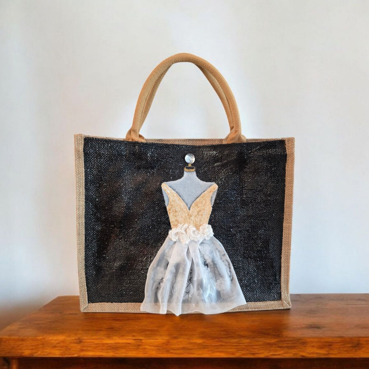 Black jute tote bag with hand-painted white wedding dress design and beaded embellishments.
