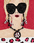 close up of Hand-painted jute tote bag featuring a stylish blonde woman wearing oversized black sunglasses and an off-the-shoulder leopard print top against a bold red background.