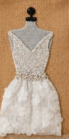 close up of Hand-painted jute tote bag featuring an embellished ivory cocktail dress design with textured floral appliqué skirt, sparkling bodice details, and elegant bridal-inspired accents on a gold jute background