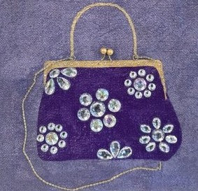 close up of Hand-painted lavender jute tote bag featuring an embellished purple vintage-style purse design with sparkling jewel accents and dimensional floral details. Elegant fashion-inspired statement tote with natural jute trim, double handles, and magnetic snap closure. Perfect for boutique fashion lovers, dressy occasions, and unique handmade gift giving.