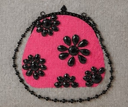 close up of Hand-painted gray jute tote bag featuring a vibrant pink embellished purse design with black jeweled floral accents and sparkling bead details.