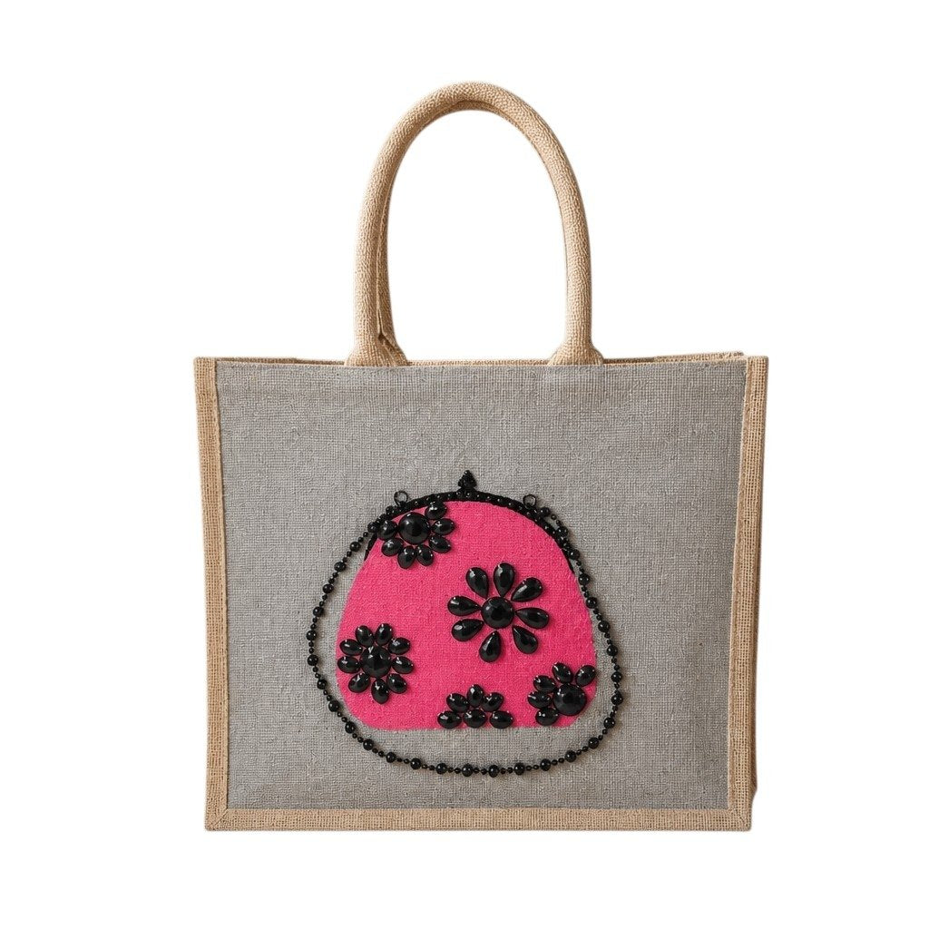 Hand-painted gray jute tote bag featuring a vibrant pink embellished purse design with black jeweled floral accents and sparkling bead details.