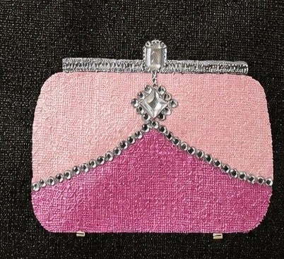 close up of Hand-painted black jute tote bag featuring a chic pink clutch purse design with silver embellishment details, perfect for adding a playful pop of glamour to everyday style.