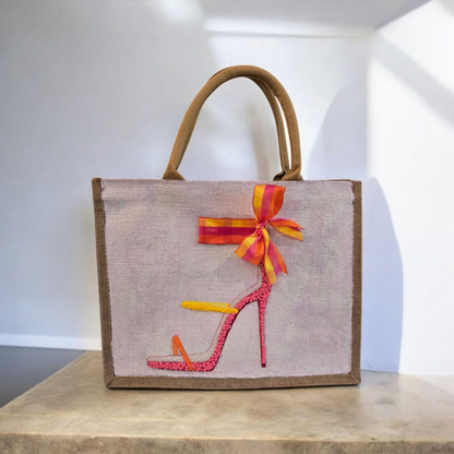 Off white jute tote bag with hand-painted high heel sandals in vibrant colors, accented with bead details.