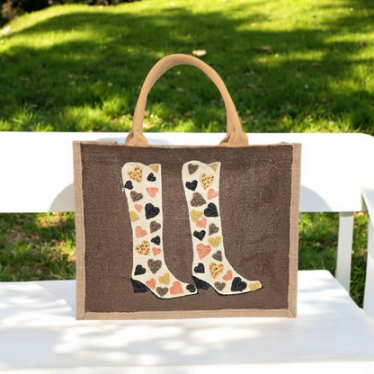 Brown jute tote bag with hand-painted cowboy boots decorated in metallic-colored hearts, accented with beads.