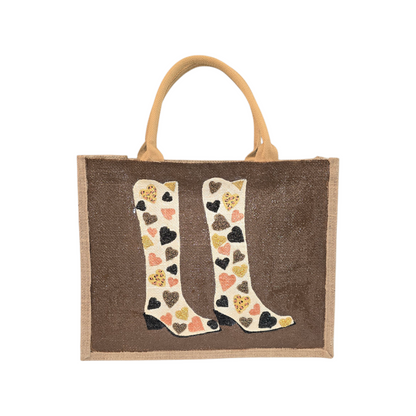Brown jute tote bag with hand-painted cowboy boots decorated in metallic-colored hearts, accented with beads.