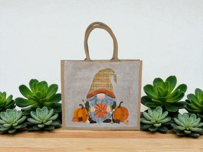 Hand-painted Fall Gnome tote bag with sunflowers, acorns, and berries on metallic jute background