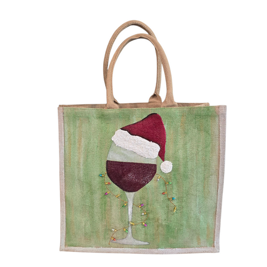 Hand-painted jute tote with a wine glass wearing a Santa hat and tiny holiday lights.