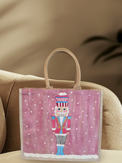 Hand-painted pink Nutcracker on a snowy background, on a jute tote bag.