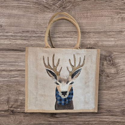 Hand-painted jute tote featuring a reindeer wearing a blue buffalo-plaid scarf.