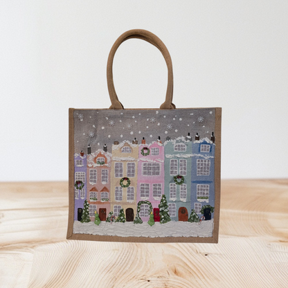 Hand-painted pastel gingerbread row houses in the snow on jute tote, Holiday village street artwork on artisan lined tote, Pastel Christmas houses tote with wreaths and snowfall