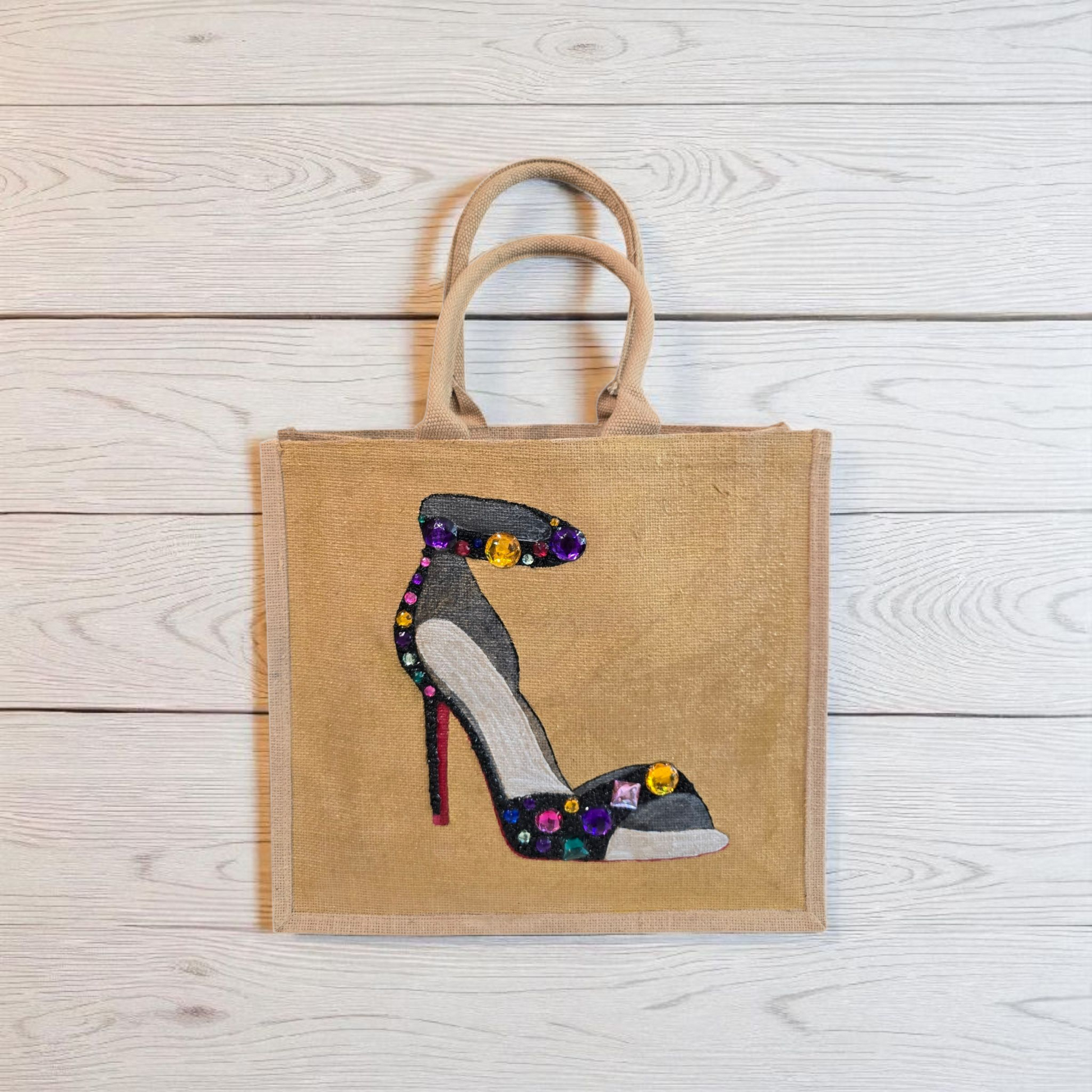 Hand-painted black stiletto tote bag with gold jeweled accents on natural jute background