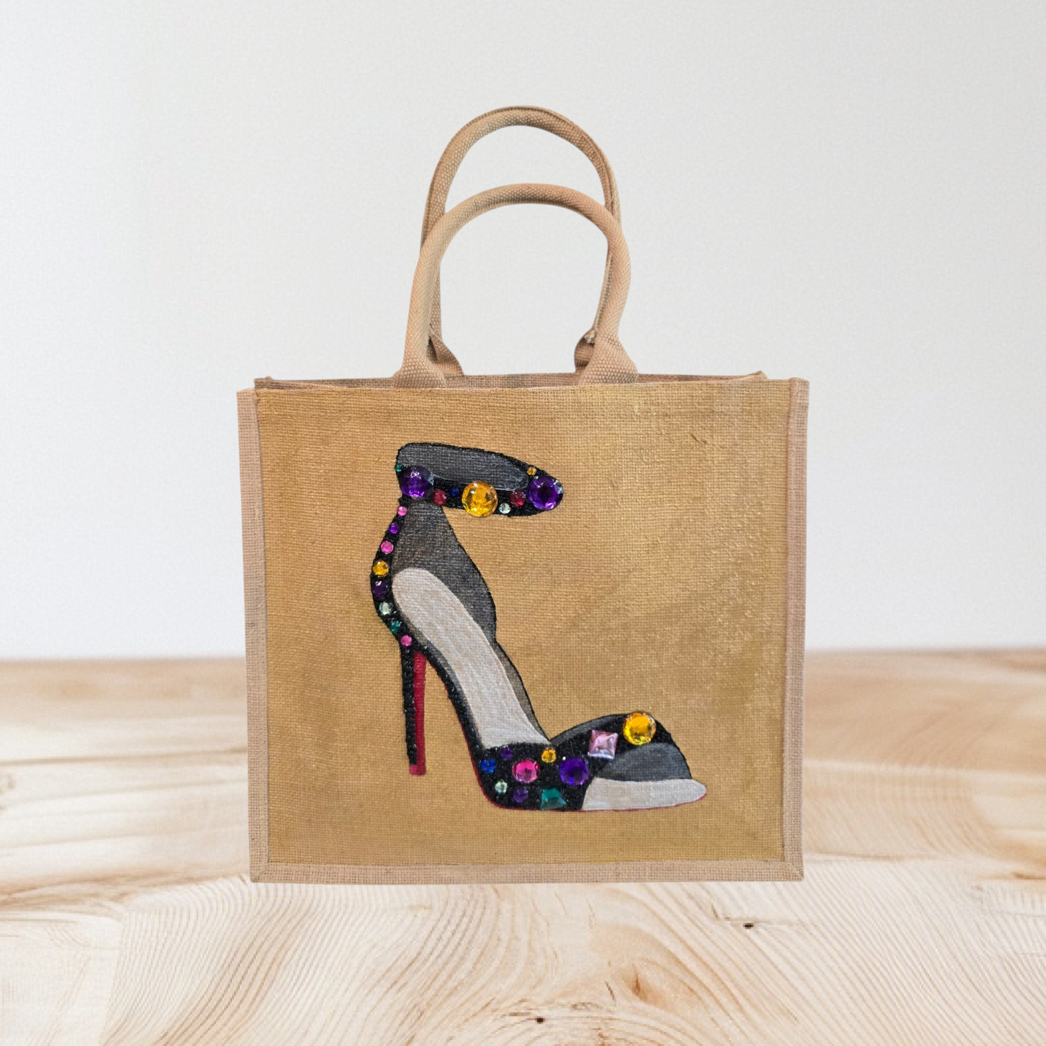 Hand-painted black stiletto tote bag with gold jeweled accents on natural jute background