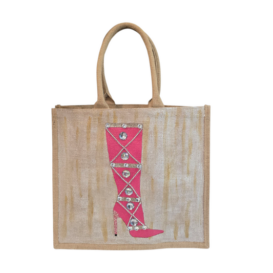 Hand-painted pink rhinestone boot tote bag on natural jute background