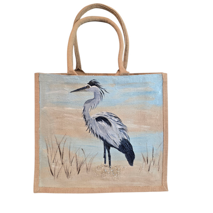 hand painted blue heron with a beachy background embellished with glitter glass on jute tote