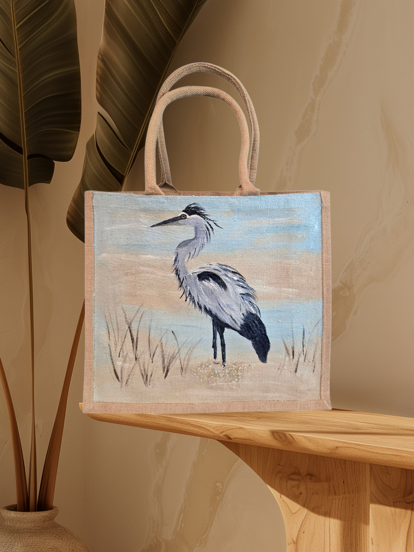 hand painted blue heron with a beachy background embellished with glitter glass on jute tote