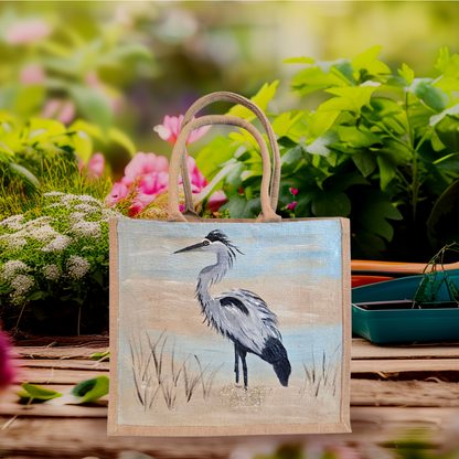 hand painted blue heron with a beachy background embellished with glitter glass on jute tote