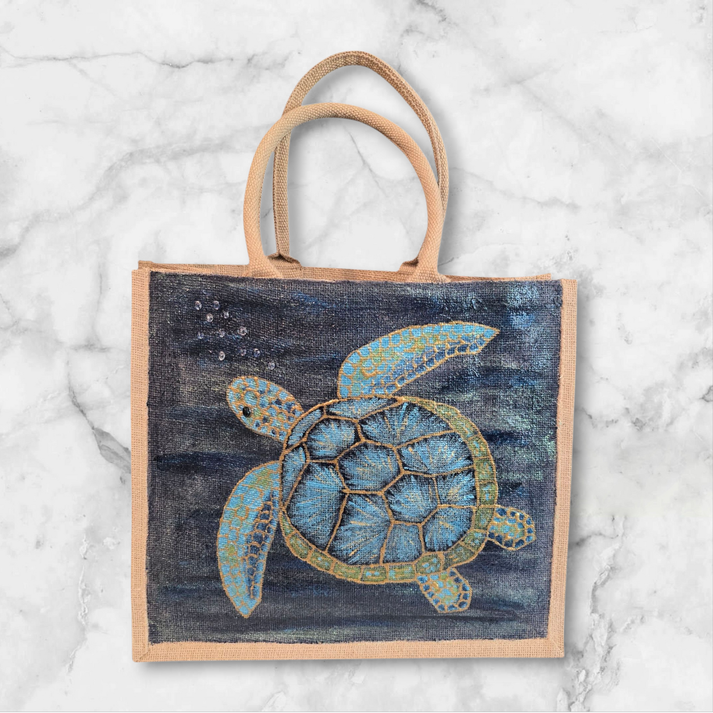 sea turtle hand-painted on burlap jute tote bag in blues, greens and golds on a navy metallic background.