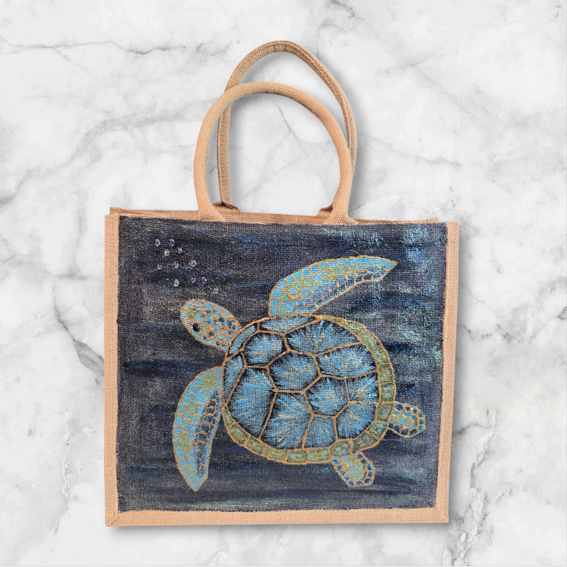 sea turtle hand-painted on burlap jute tote bag in blues, greens and golds on a navy metallic background.