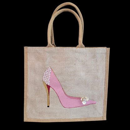 Pink Stiletto hand painted on jute tote bag embellished with jewels and pearls on an off white metallic background.