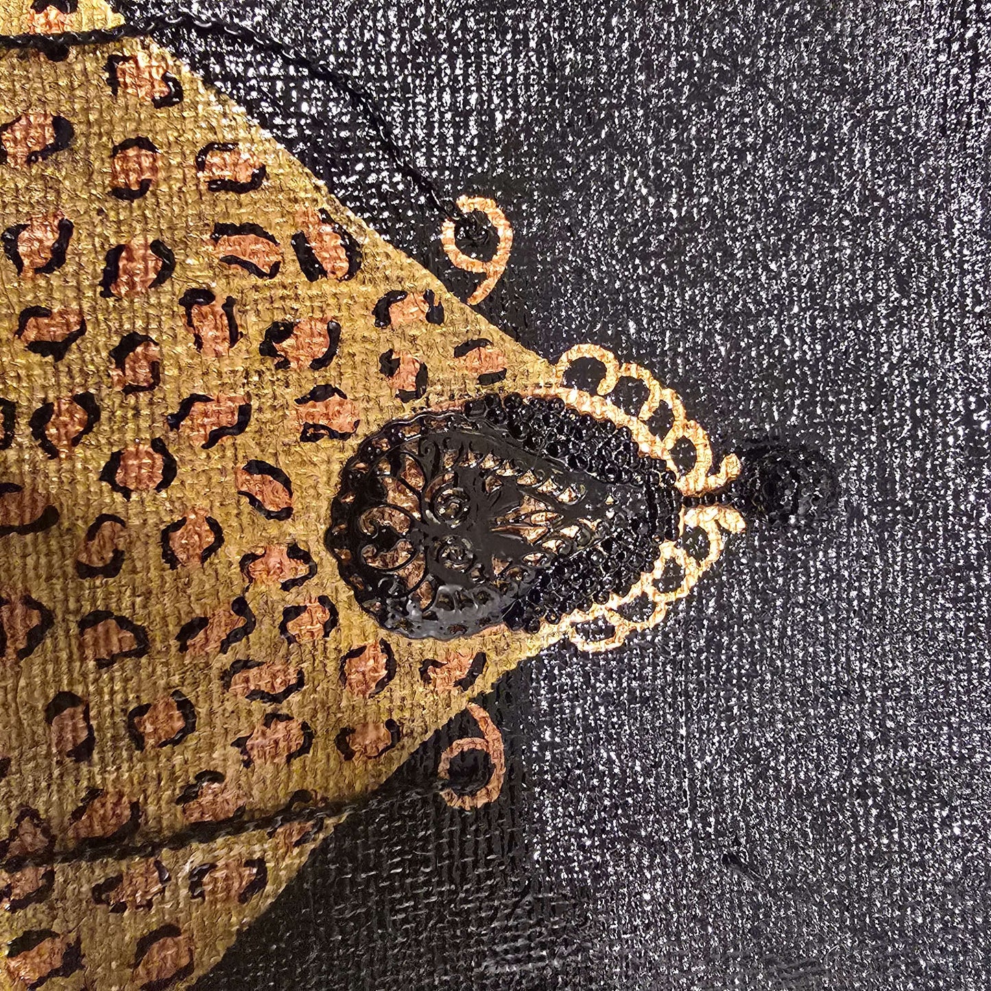 close up of Hand-painted black jute purse tote with gold leopard design and chain handles