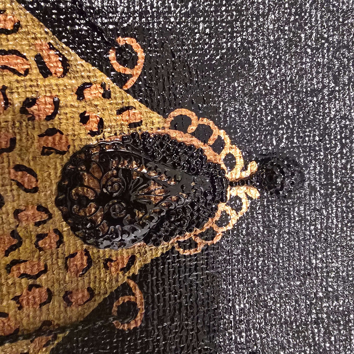 close up of Hand-painted black jute purse tote with gold leopard design and chain handles