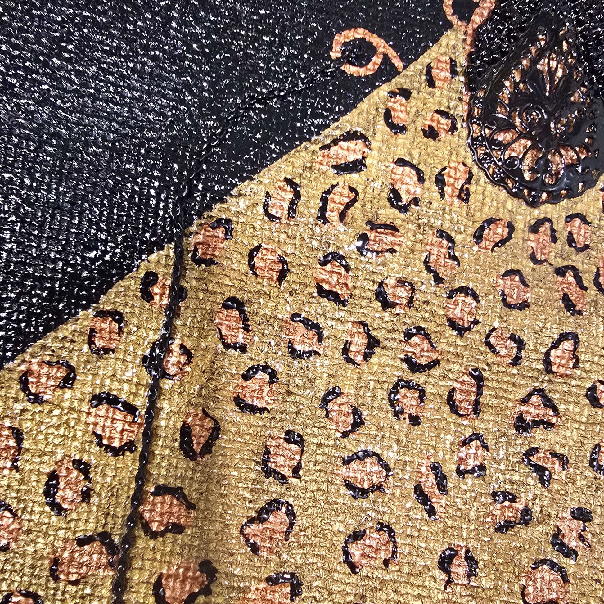 close up of Hand-painted black jute purse tote with gold leopard design and chain handles 