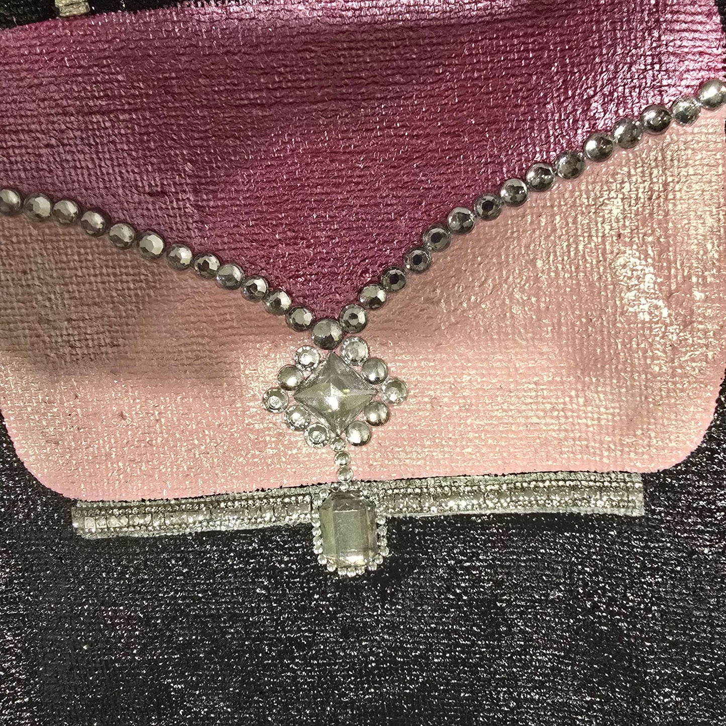 close up of Pink jeweled purse design hand-painted on black jute tote bag